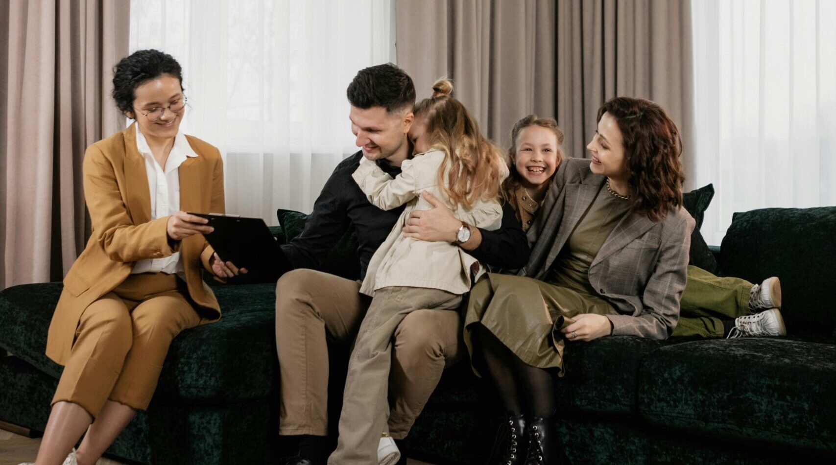 Home A joyful family consults with a real estate agent in their modern living room.